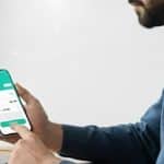 Person paying LESCO electricity bill online via Udhaar Book app on laptop